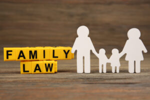 Cutout family and blocks with letters regarding child-custody and family-law concept